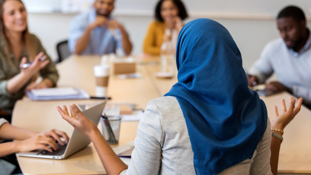 Professional Set Designer chairing a meeting of her colleagues