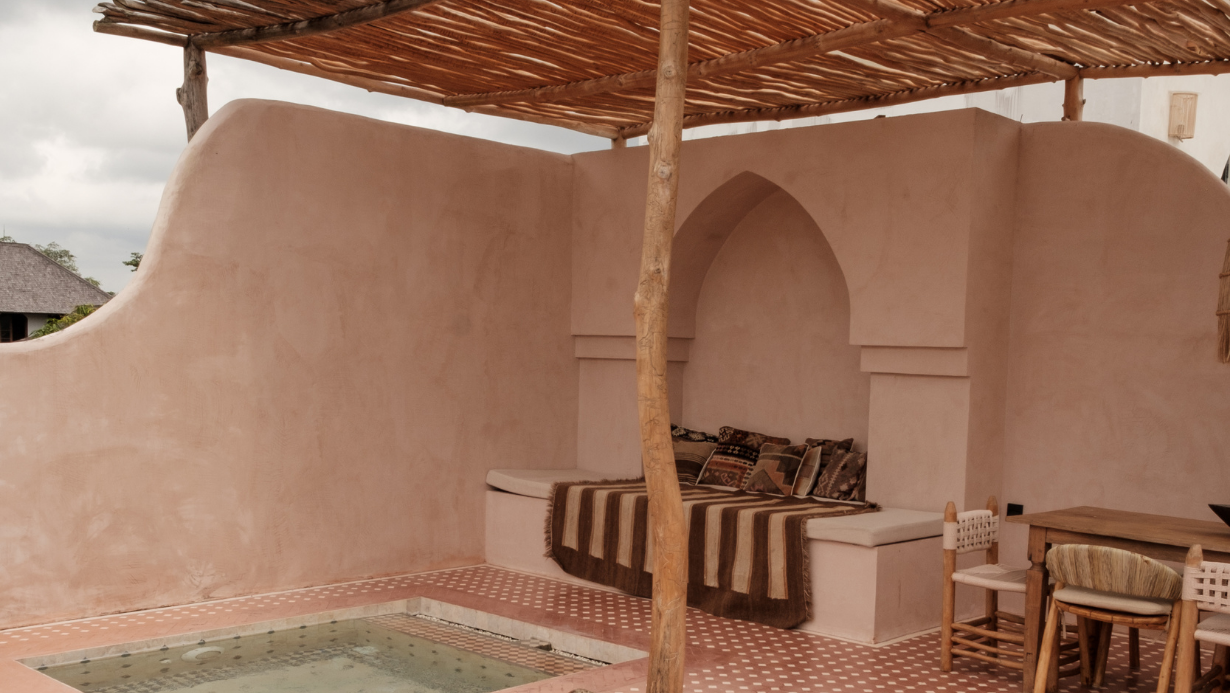 Mud walls of a luxury outdoor lounge area with pool